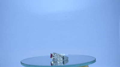 Elegant Silver-Tone Ring with Red Gemstone and Sparkling Accents - Image 3